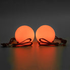 Spinballs glow poi glowing orange with a dark background