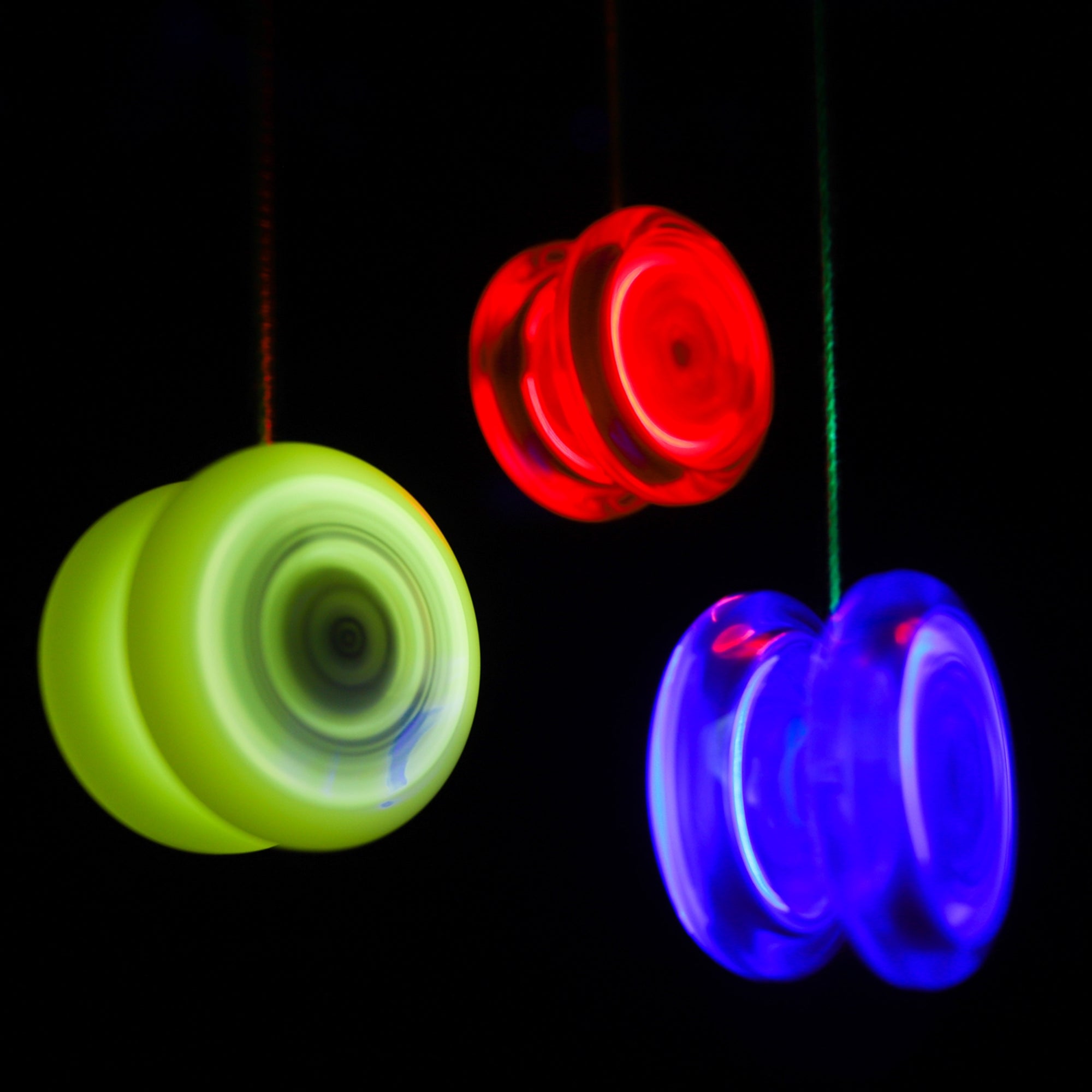 one red, one yellow, one blue yoyo spinning